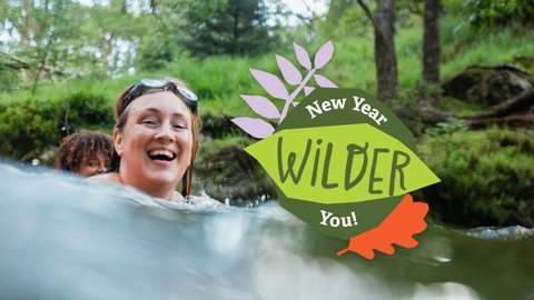 Image of a woman wild swimming with friends, with the New Year Wilder You logo to her right