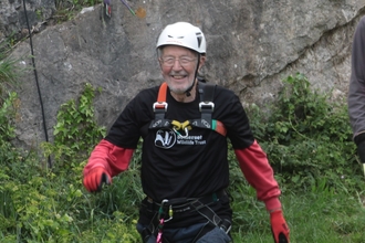 Happy abseiler at the bottom of the cliff