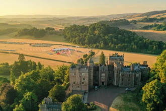 Sunset views over Dunster Castle with the SW Coast 50 event village in the background