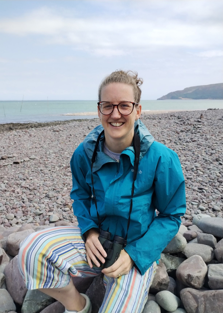 Image of Vanessa Lloyd sat on a beach.