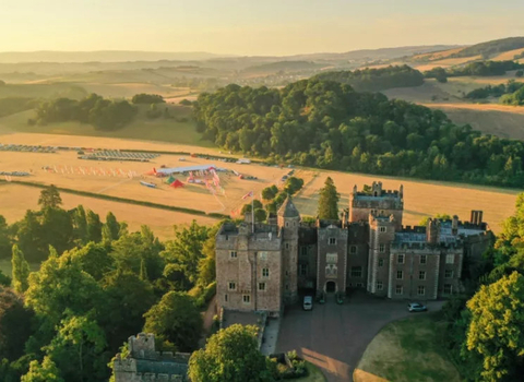 Sunset views over Dunster Castle with the SW Coast 50 event village in the background