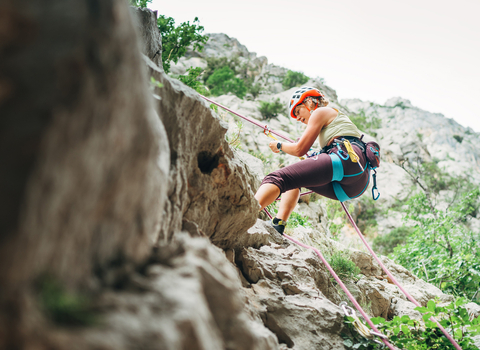 Image of a woman abseiling