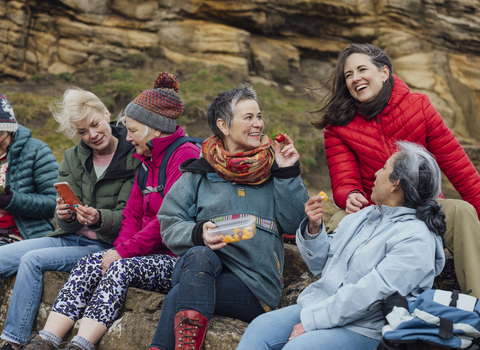 Image of a group of women enjoying a chat while sat outdoors